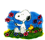Snoopy sitting on a bed of flowers.